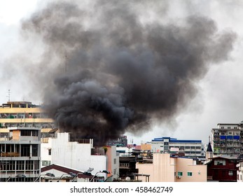 Fire Burning And Black Smoke Over The Commercial Building.