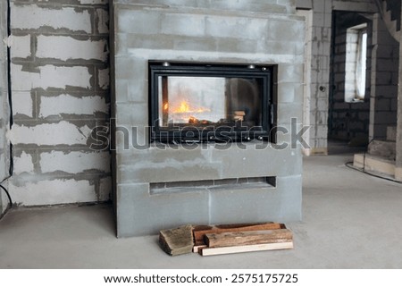 Fire burning in freshly installed fireplace in newly built house. Repair of new home after construction.