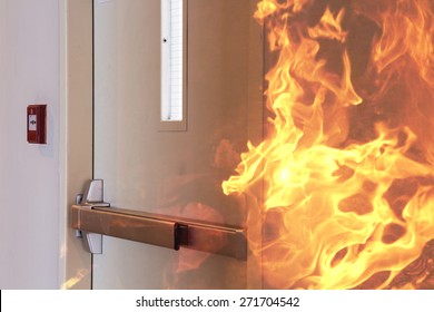 Fire burning in front of the closed door.