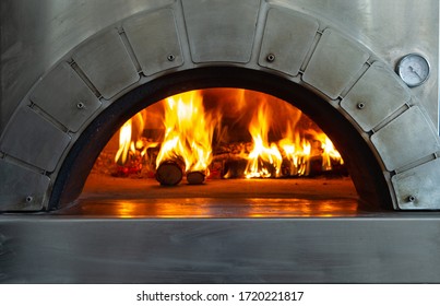 A fire is burning in a pizza oven. selective focus - Powered by Shutterstock