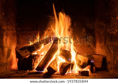 A fire burns in a fireplace, Fire to keep warm