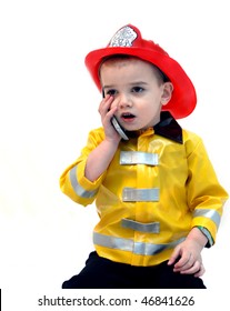 Fire Chief Answers An Emergency Phone Call.  He Is Holding A Cell Phone To His Ear And Is Wearing A Fireman's Costume.