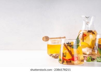 Fire cider, hot drink with apple cider vinegar, spices, herb and citrus slices. Organic raw natural flu and cold remedy drink, immune support, anti-inflammatory recipe - Powered by Shutterstock