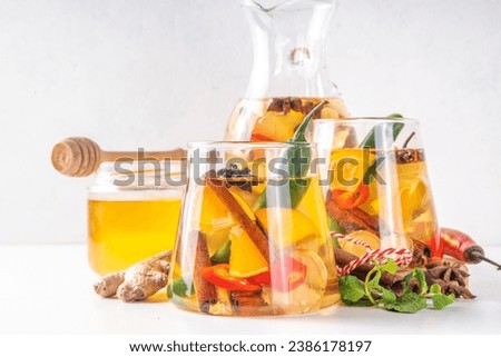 Fire cider, hot drink with apple cider vinegar, spices, herb and citrus slices. Organic raw natural flu and cold remedy drink, immune support, anti-inflammatory recipe