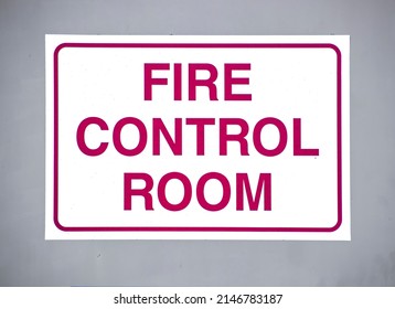 Fire Control Room Sign With Red Letters On White Background  On Outside Grey Metal Door - Closeup