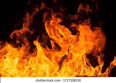 Fire creates infinity shapes when it burns. The orange from the flame and the black backgroud creates interesting textures. Flames from hell. Burning power. - Shutterstock ID 1717108150
