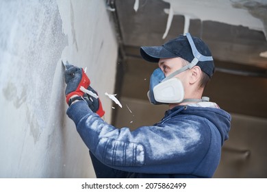 fire damage and restoration indoor interior. removing damaged paint layer - Shutterstock ID 2075862499