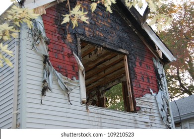 Fire Damaged Home With Melted Siding And Broken Glassfire Damaged Home With Melted Siding And Broken Glass