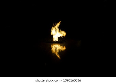 fire dance with reflection on black background                               