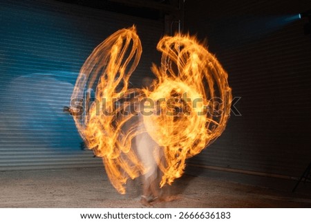 Fire dancer captivates slow motion swirling flames grace