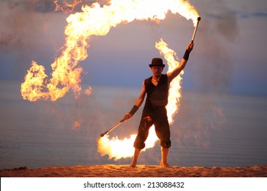 Fire dancer twirling fire torch; impressive open air performance 