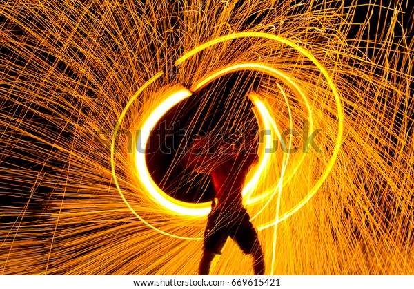 Fire dancers\
Swing fire dancing show fire show on the beach dance man juggling\
with fire , Koh Samet,\
Thailand