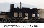 Fire Debris of Houses in a small town with smoke in sky. Caused by Forest Wildfires in Lytton, British Columbia, Canada.