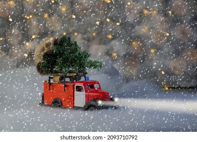 a fire department car is carrying a Christmas tree, it is snowing, a blizzard, headlights are on, bokeh - Powered by Shutterstock