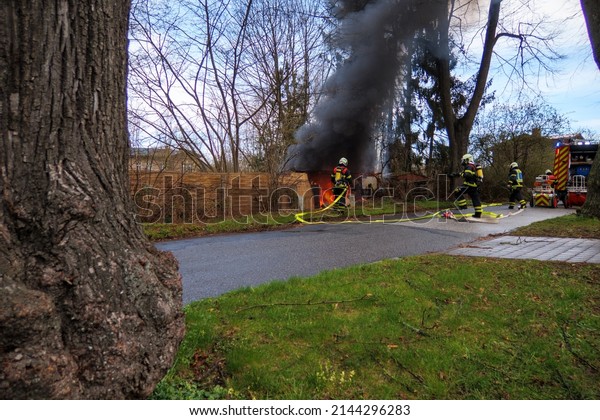 the fire department extinguishes a garden house that\
has caught fire