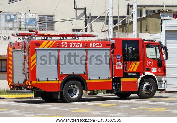 Fire\
Department. Israeli fire truck with text. Fire engine car. Nobody\
in the vehicle. 9 May 2018. Tel Aviv.\
Israel