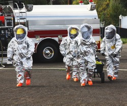 Fire Departments & Emergency Response Teams Conduct Disaster Preparedness Drills. This HAZMAT Team Is Suited Up With PPE To Protect Them From Hazardous Materials As They Investigate This Disaster.
