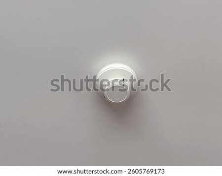 Fire detection sensor installed on a ceiling for early smoke and heat detection, essential fire safety equipment in homes and offices, concept of fire protection, risk prevention, security system