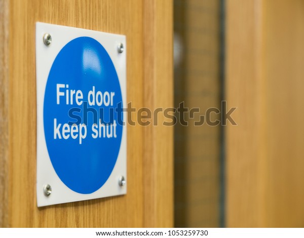 Fire Door Keep\
Shut Sign on a Wooden Fire\
Door