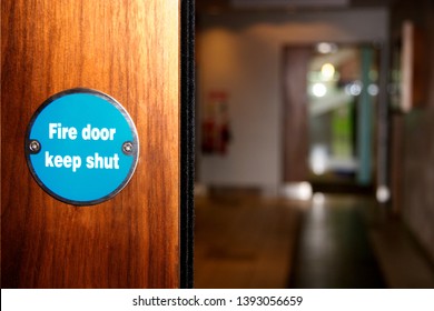 
Fire Door Sign On A Wooden Door In A Public Building.