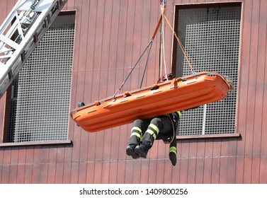 Fire Drill And The Brave Firemen During A Rescue With Stretcher