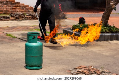 Fire Drill And Rescue Emergency Training In The School With Copy Space. Flame From Green Gas Tank.