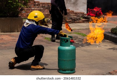 Fire Drill And Rescue Emergency Training In The School With Copy Space. Flame From Green Gas Tank With Fireman.