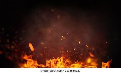 Fire embers particles over black background. Fire sparks background. Abstract dark glitter fire particles lights. 