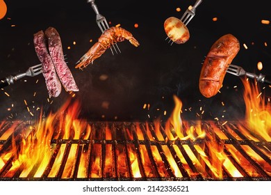 Fire embers particles over black background.  Grill Background - Empty Fired Barbecue On Black . Abstract dark glitter fire particles lights. 