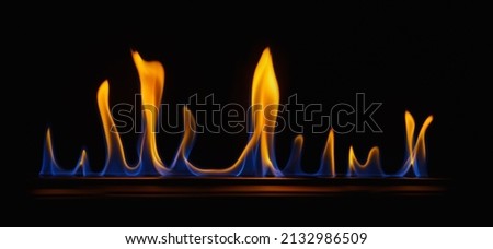 Fire embers particles over black background. Gas fire background. Abstract dark glitter fire particles lights. 