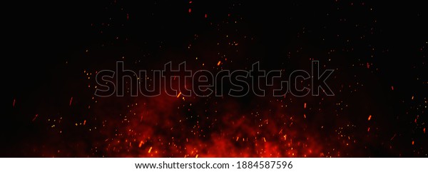 Fire embers particles over black background. Fire\
sparks background. Abstract dark glitter fire particles lights.\
bonfire in motion blur.