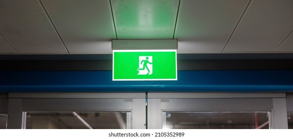 Fire Emergency Exit Sign On The Wall Inside Building At Subway Train Station. Safety Concept