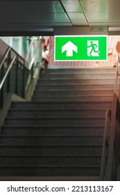 Fire Emergency Exit Sign On The Wall Inside Building At Subway Train Station. Safety Concept