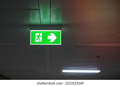 Fire Emergency Exit Sign On The Wall Inside Building At Subway Train Station. Safety Concept