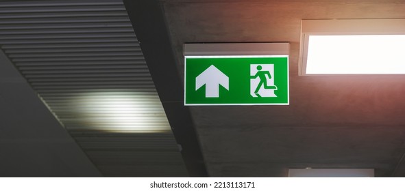 Fire Emergency Exit Sign On The Wall Inside Building At Subway Train Station. Safety Concept