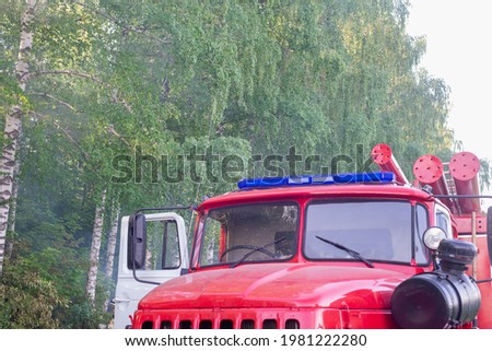 A fire engine came to put out the fire in the forest.