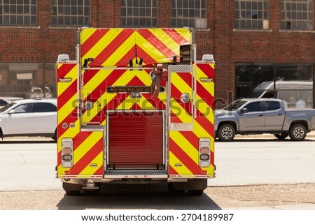 A fire engine pulls away onto a city street.
