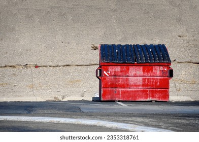 Fire engine red dumpster sitting alone in the California desert