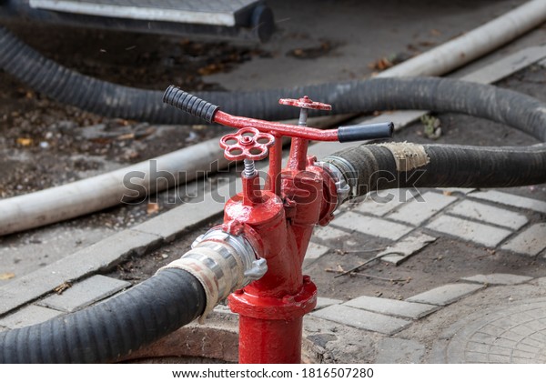 Fire engine rescue equipment. Pumps and hoses\
supplying water.