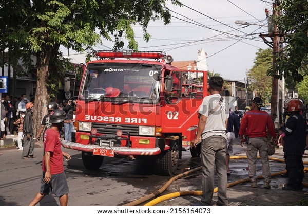 fire engines are on standby and trying to extinguish\
the fire at the furniture warehouse fire site. : Yogyakarta,\
Indonesia - 12 May 2022