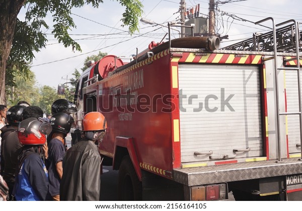 fire engines are on standby and trying to extinguish\
the fire at the furniture warehouse fire site. : Yogyakarta,\
Indonesia - 12 May 2022