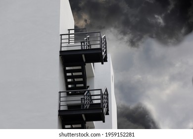fire escape stair steel with black smoke. black outdoor metal stair of building. concept : escape from fire.