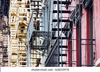 Fire escapes on the side of vintage buildings in the East Village neighborhood of Manhattan, New York City NYC