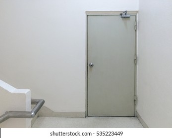 Fire Exit Door And Stairs In Empty White Office Building