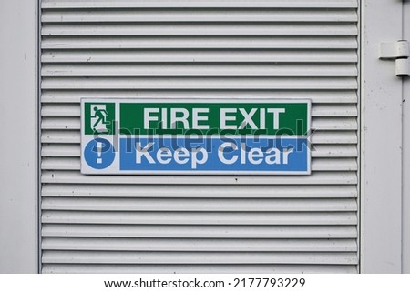 Fire exit, keep clear metal sign on doors of a building 