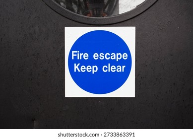 Fire exit keep clear sign on construction building site door