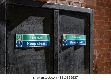 Fire exit keep clear sign on construction building site door