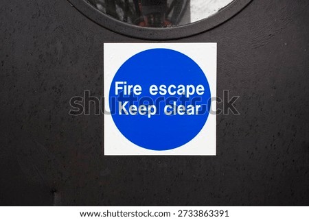 Fire exit keep clear sign on construction building site door