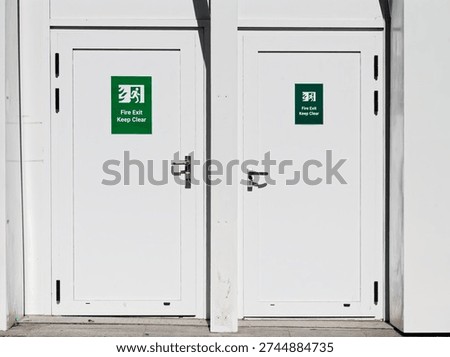 Fire exit keep clear sign on construction building site door