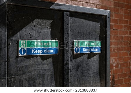 Fire exit keep clear sign on construction building site door